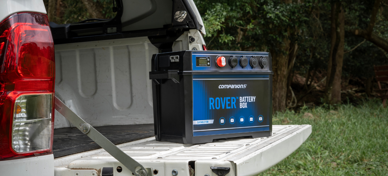 White pickup with Rover Battery Box showing display, switch, outlets.