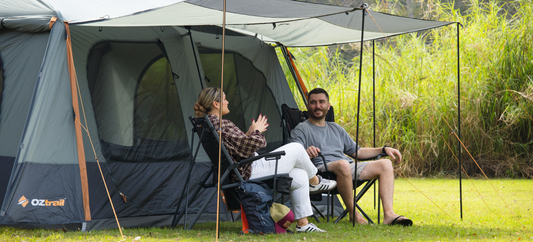 Adults under OZtrail Fast Frame Headland 10P Tent relaxing